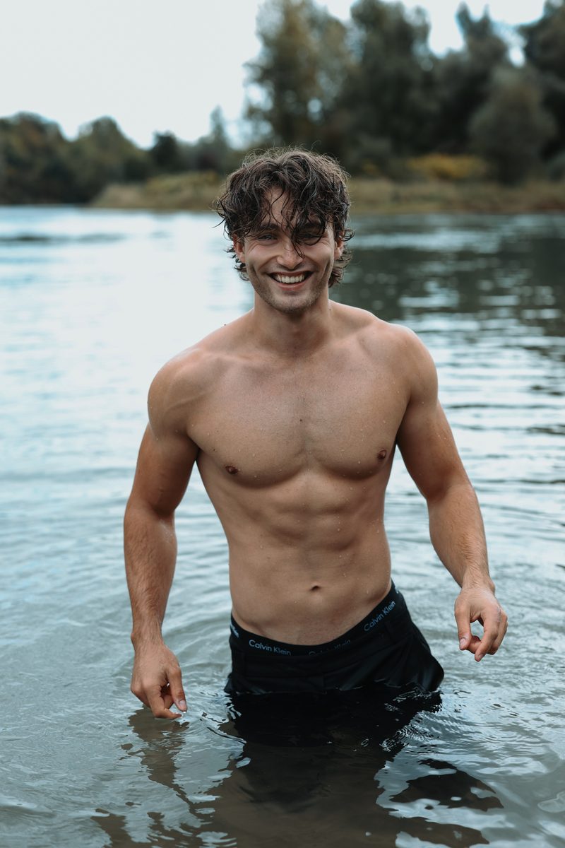 Pascal Sander standing in a river, laughing