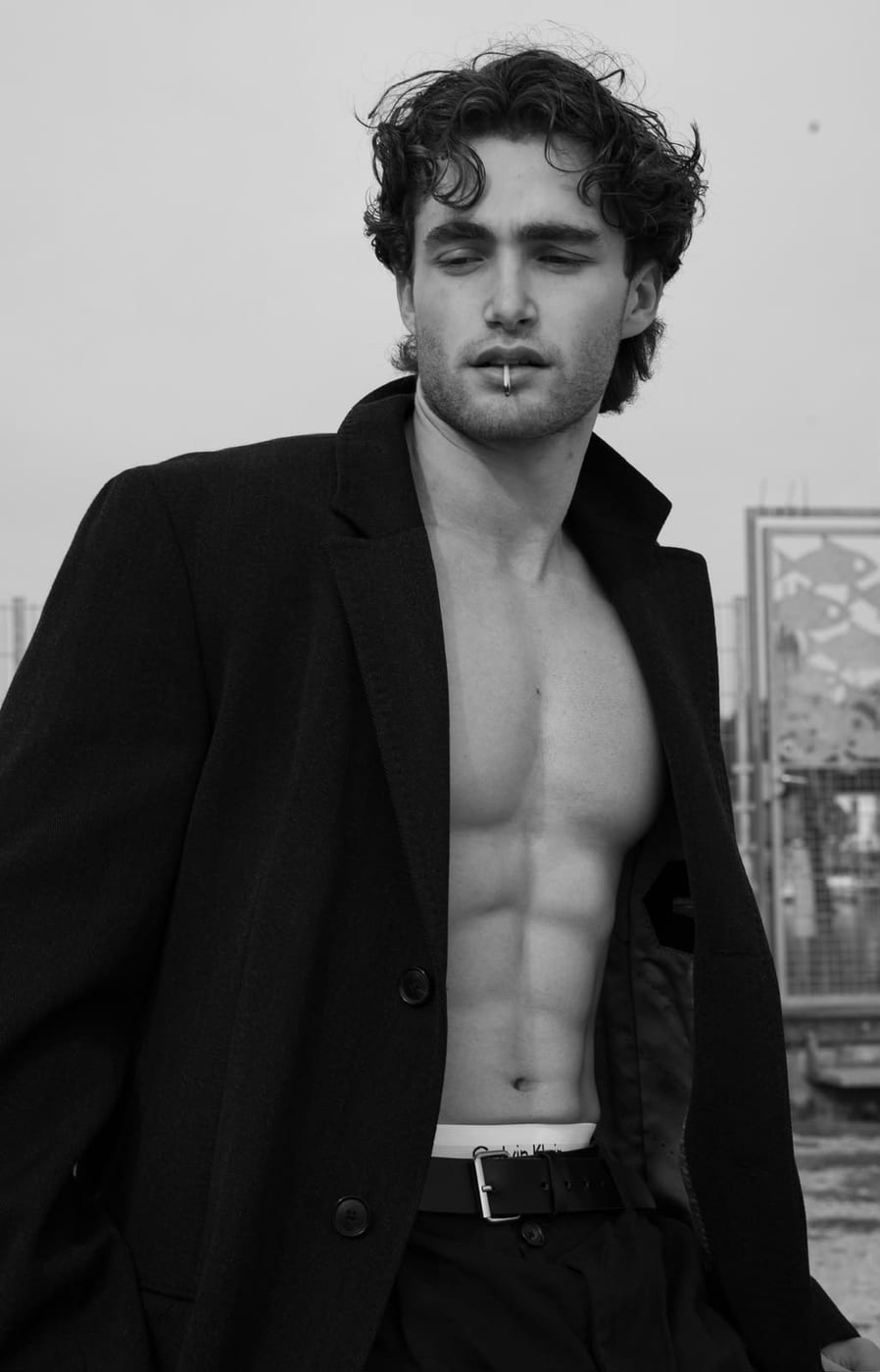 Pascal Sander in an open black blazer on a city rooftop