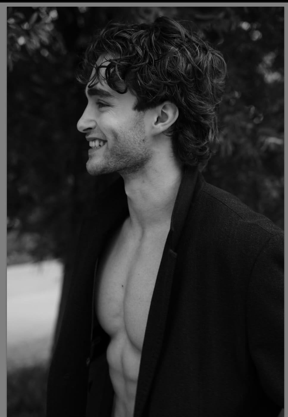 Pascal Sander in profile outdoors, open jacket, black and white
