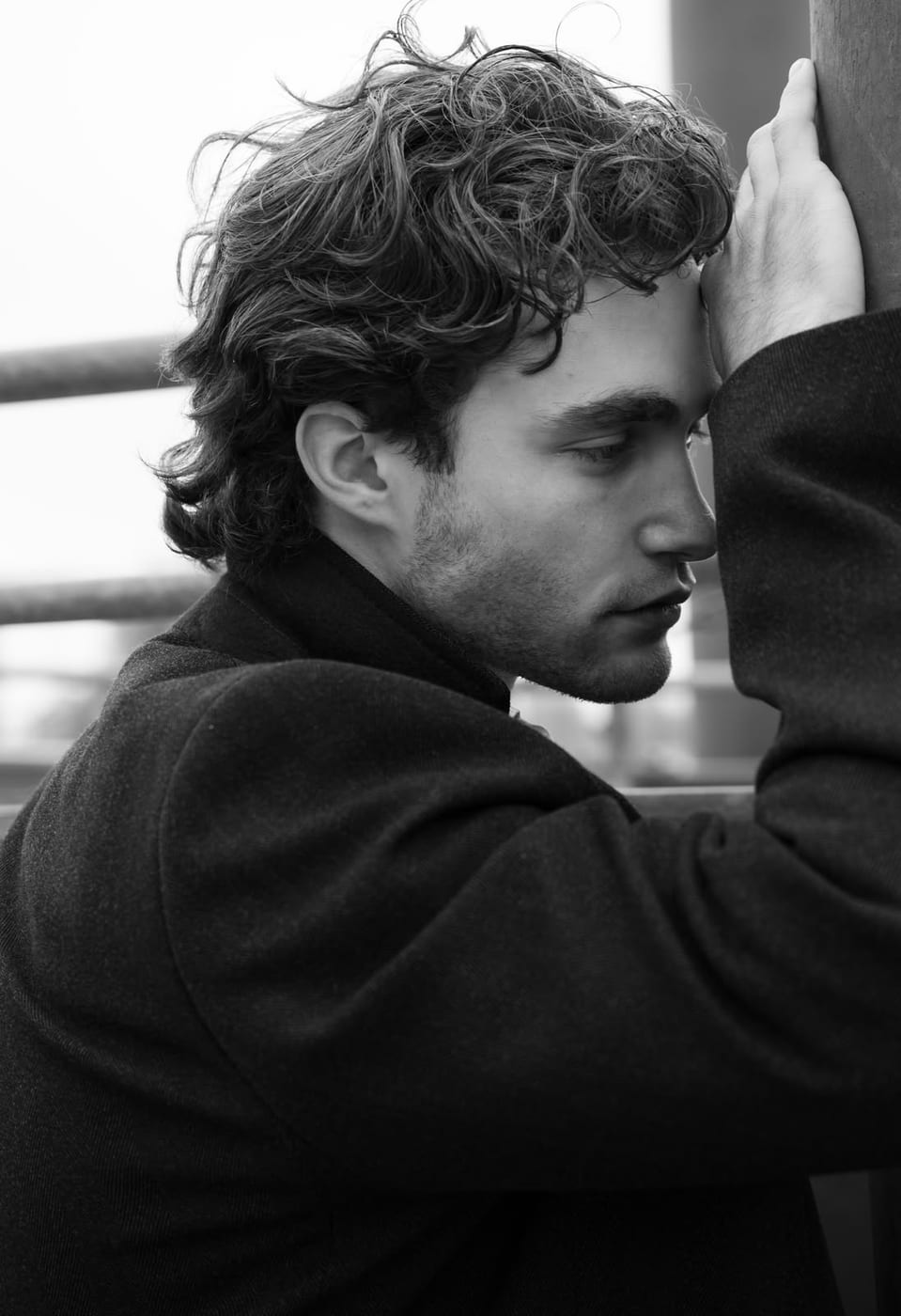 Pascal Sander dressed in black, seated by a window in low light