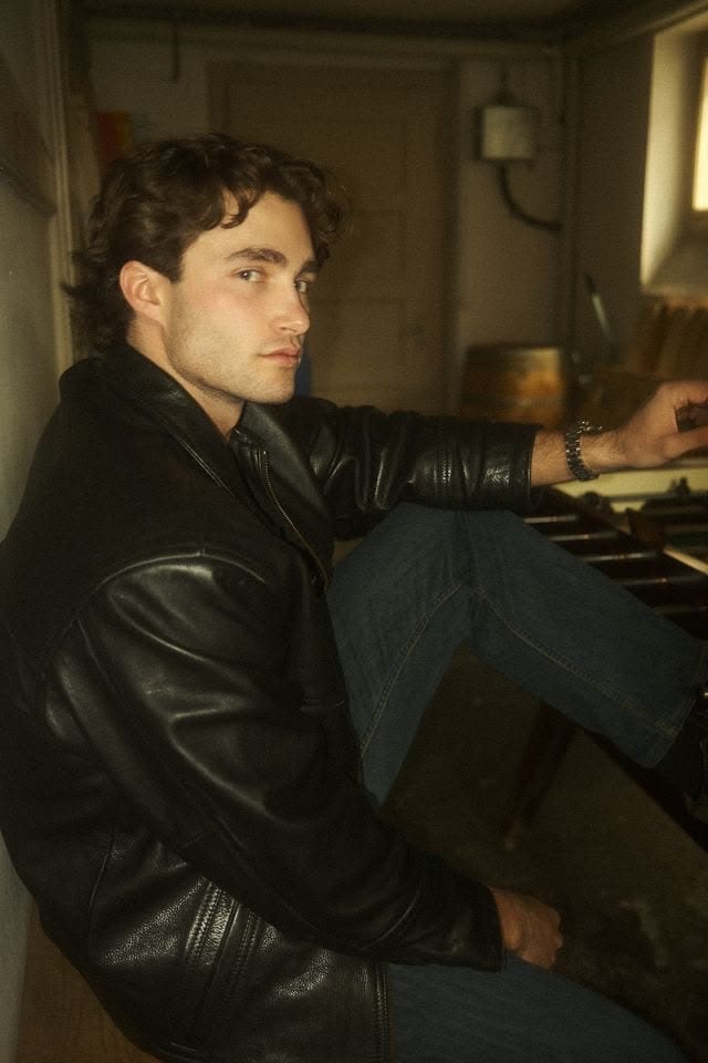 Pascal Sander in a brown leather jacket indoors