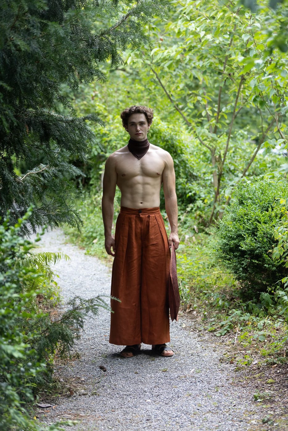 Pascal Sander outdoors in a long wrap skirt on a garden path