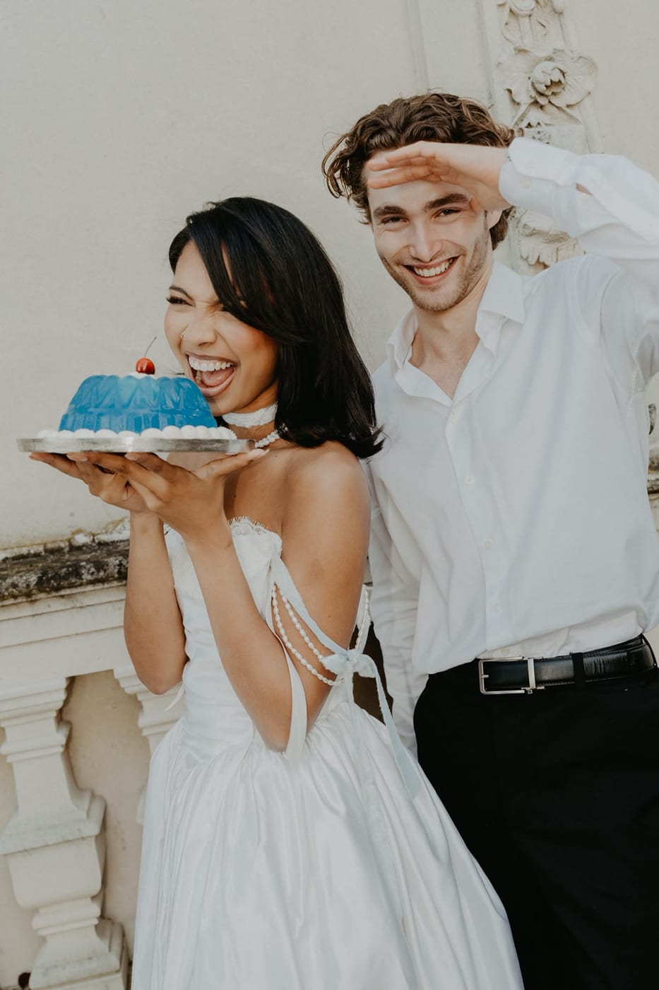 Pascal Sander and a partner holding a cake, laughing