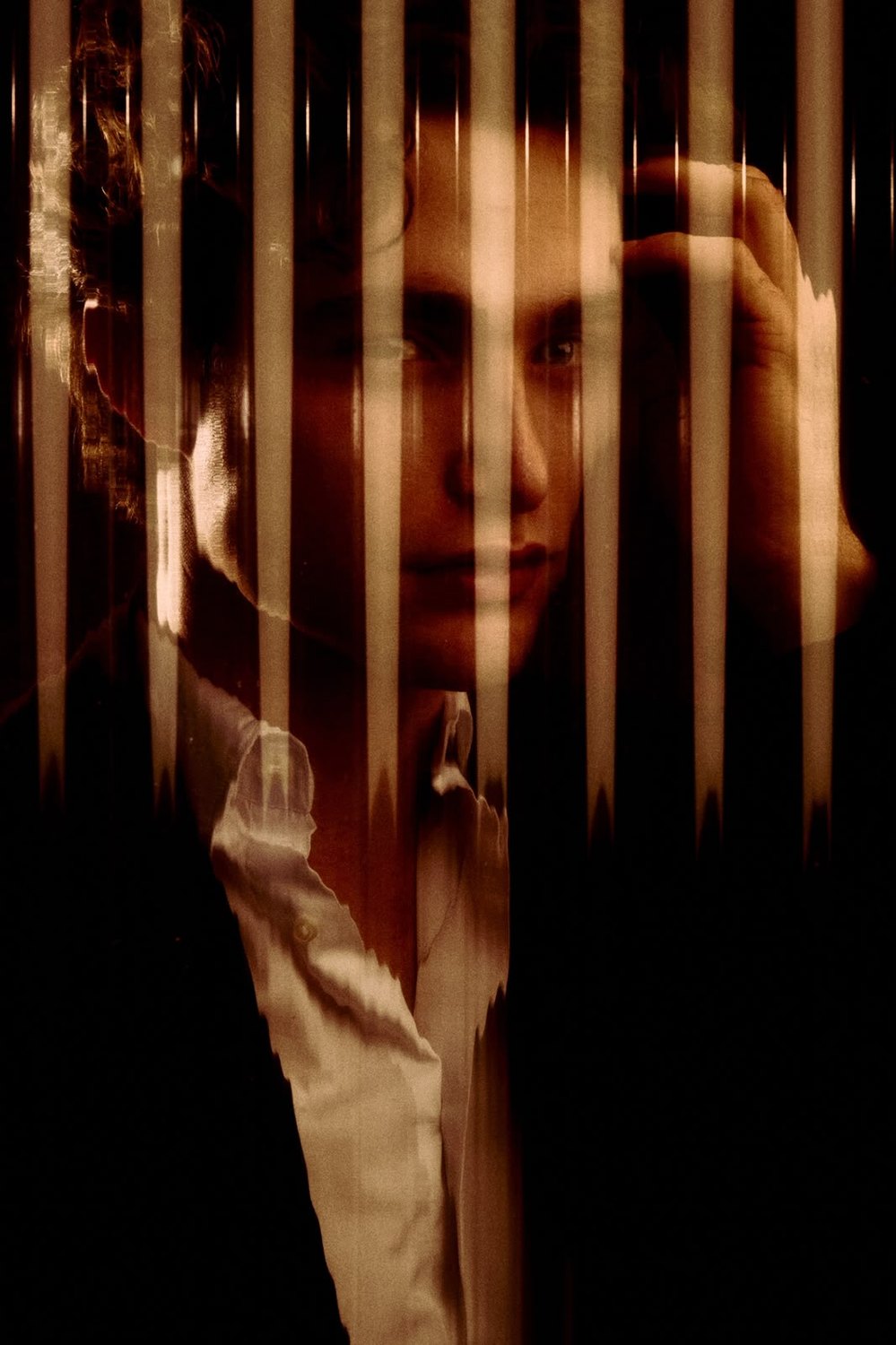 Pascal Sander behind textured glass, face half obscured
