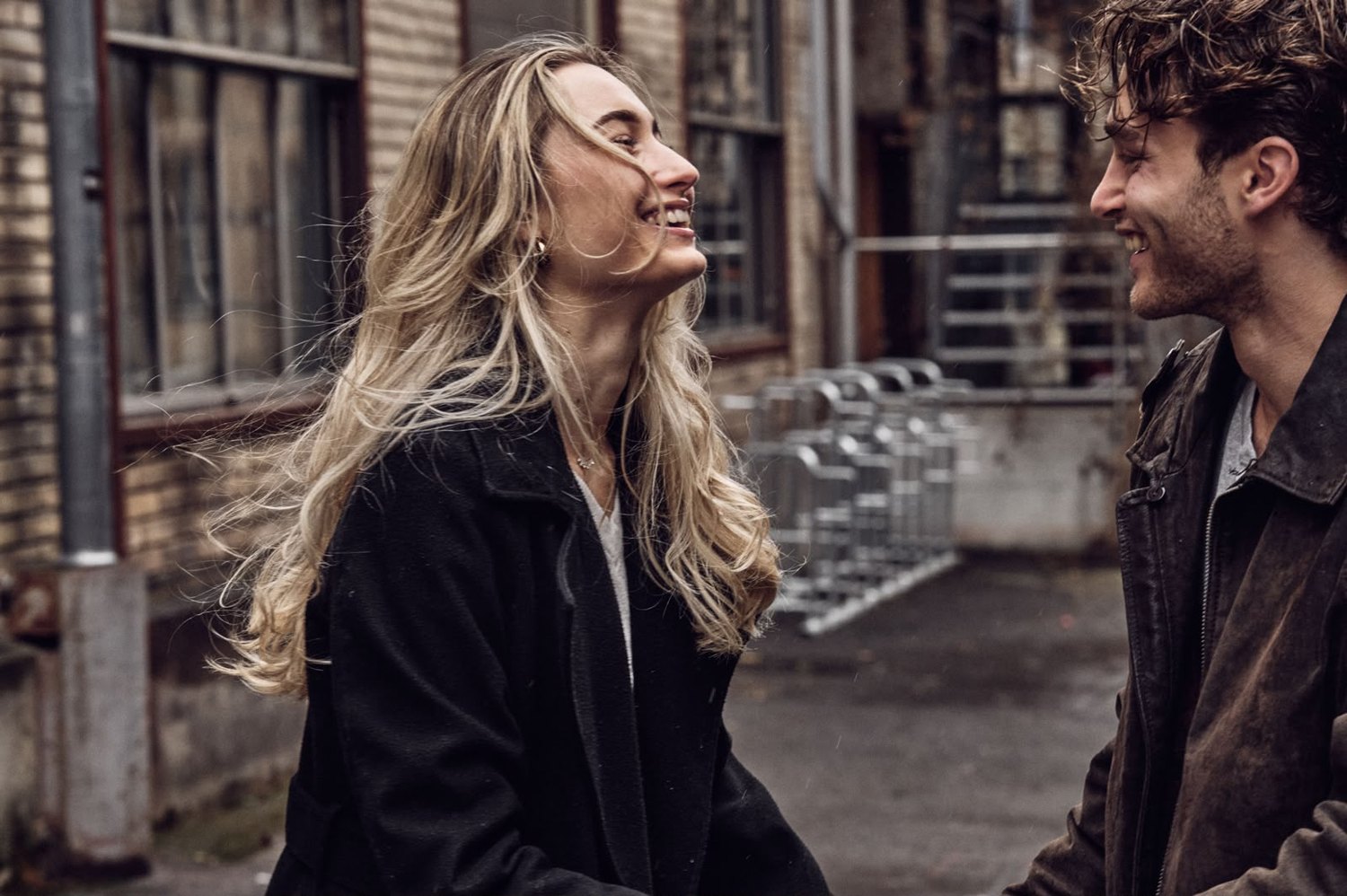Pascal Sander and a partner on an industrial street, black and white
