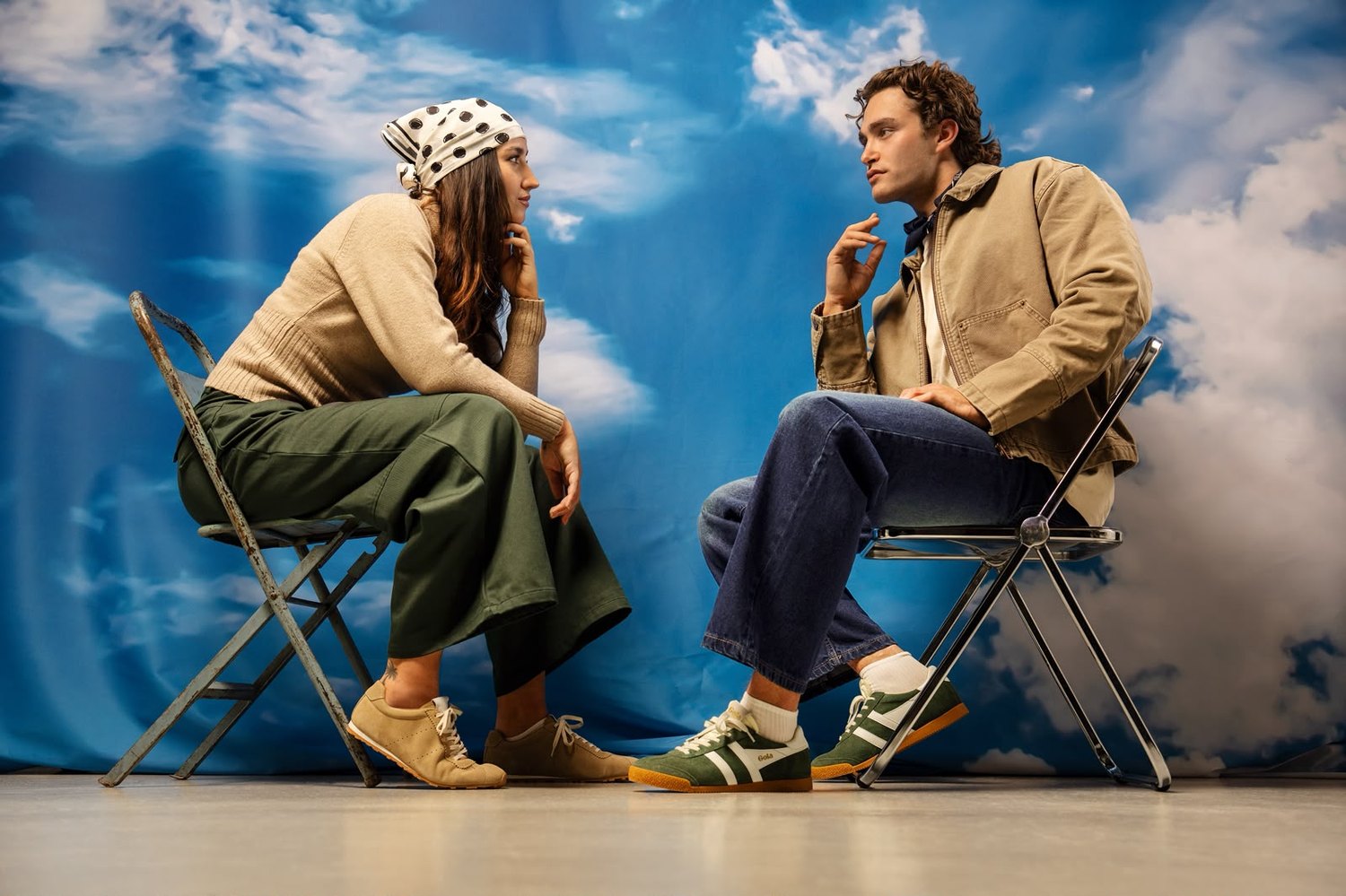 Pascal Sander and a model seated before a sky backdrop, Gola campaign