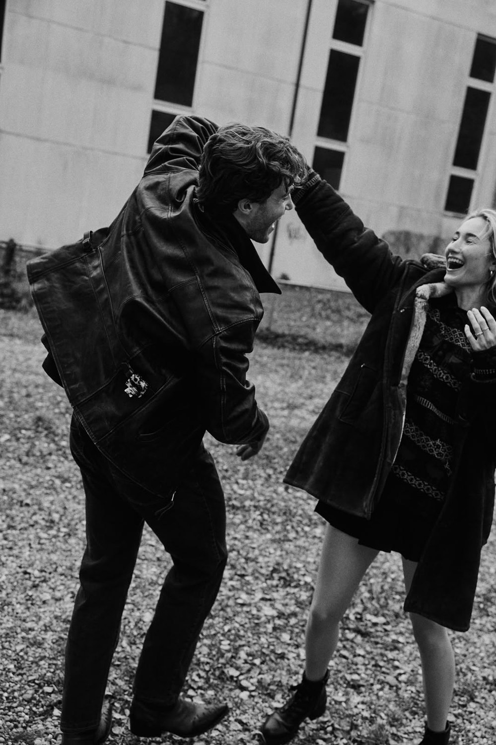 Pascal Sander and a partner in leather jackets in a courtyard