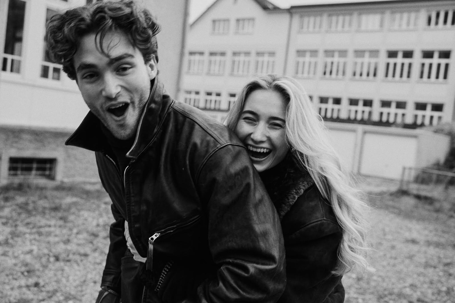 Pascal Sander and a partner laughing in a schoolyard