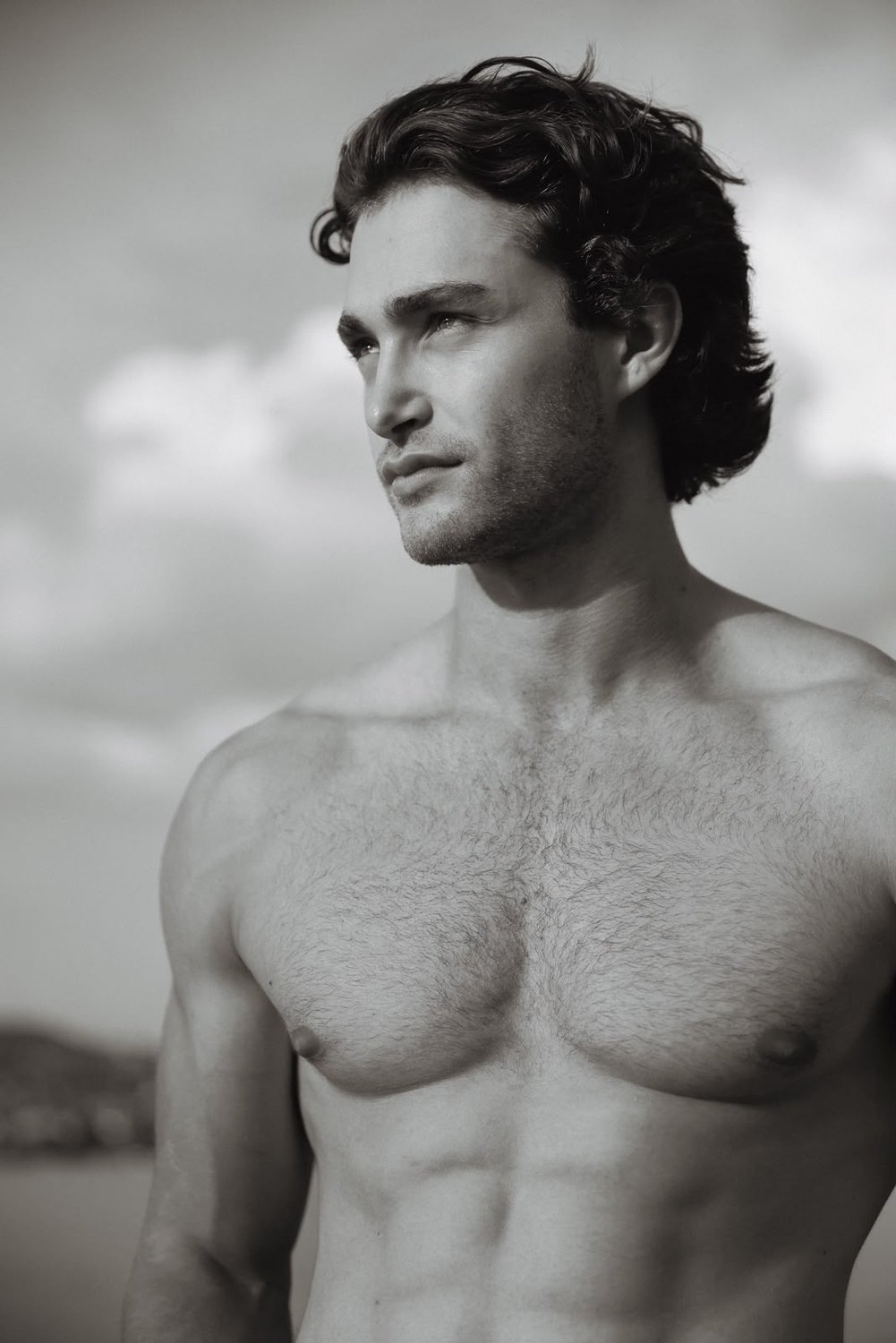 Pascal Sander shirtless outdoors, looking to the side, black and white